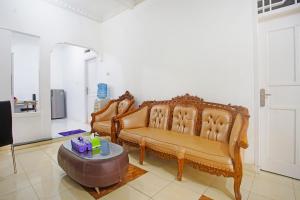 a living room with two chairs and a table at OYO 91460 Guest House Kencana Syariah in Bandar Lampung
