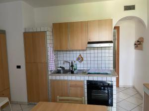 a kitchen with a sink and a stove top oven at SALENTO - Casa vacanza - Torre dell’orso in Torre dell'Orso
