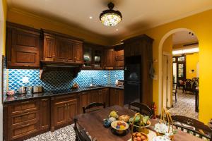 a kitchen with wooden cabinets and a wooden table at Tonkin House in Hanoi