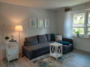 ein Wohnzimmer mit einem Sofa und einem Tisch in der Unterkunft Gemütliches, voll ausgestattetes Apartment in Halle an der Saale