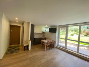 a kitchen and dining room with a table and chairs at Apartment Pusynas in Nida