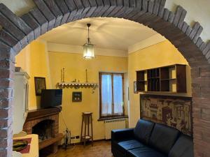 a living room with a couch and a fireplace at VACANZE A SESTOLA in Sestola