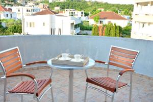 a table and chairs on a patio with a view at NEXT DOOR HOUSE in Ulcinj