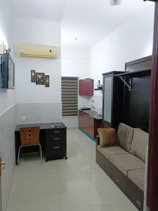 a living room with a couch and a desk at Safa Serviced Apartments in Cochin