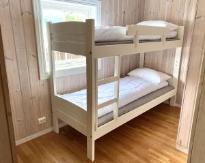 two bunk beds in a room with a window at Stryn - Faleide -hytte med fjord og fjell utsikt in Stryn
