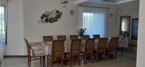 a dining room with a table and a bunch of chairs at Natura Chalet in Gîlgău