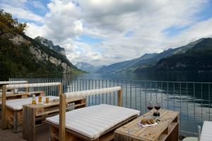 a balcony with two tables and a view of a lake at Flyhof in Weesen
