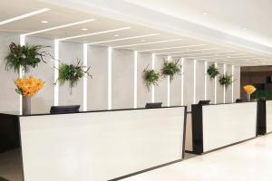 a lobby with potted plants on the wall at ILLUME Taipei in Taipei