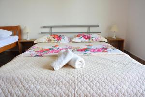 a bedroom with a bed with towels on it at NEXT DOOR HOUSE in Ulcinj