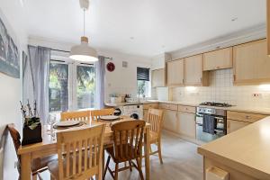 a kitchen with a table and chairs and a dining room at Quayside House by Staytor Accommodation in Exeter