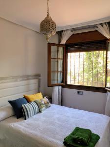 a bedroom with a bed and a window at House Parra in San Juan de los Terreros
