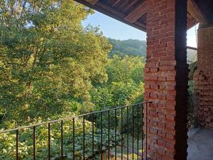 Edificio de ladrillo con balcón con vistas en A romantic suite in the countryside near Torino, en Pecetto