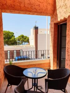 a patio with a table and chairs on a balcony at House Parra in San Juan de los Terreros