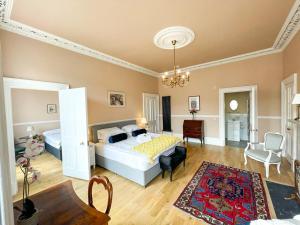 a bedroom with two beds and a living room at Remarkable 5BR Townhouse with Garden, Sleeps 12 in Edinburgh