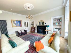 a living room with two couches and a fireplace at Remarkable 5BR Townhouse with Garden, Sleeps 12 in Edinburgh