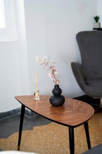 a wooden coffee table with a vase on top of it at HomeResidence 1 in Ermoupoli