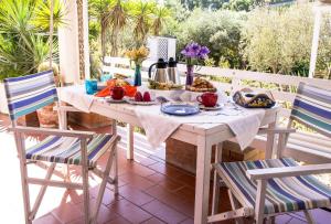 a table with a plate of food on a patio at Villa Cetta B&B in San Leone
