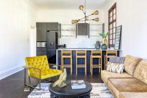 ein Wohnzimmer mit Couch und Küche in der Unterkunft Secure & Central: Villa with Views of Table Mountain in Kapstadt