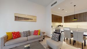a living room with a couch and a kitchen at Key View - Park Heights in Dubai