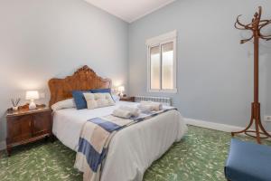 a bedroom with a large bed with two pillows on it at Orillas del Turia in Teruel