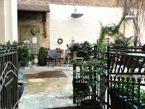 a garden with a patio with plants and a chair at Walhalla Aparthotel-Potsdam in Potsdam