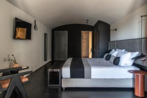 a bedroom with a large bed in a room at Nimbus Santorini in Oia