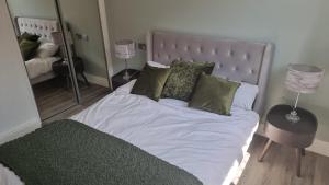a bedroom with a bed with a large mirror at Jasmin Apartments - Luxury 1 & 2 Bedroom units with Free Parking in Bushey