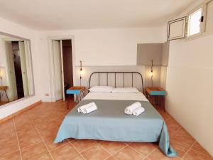 a bedroom with a bed with two towels on it at Villa Talìa in Marsala