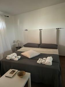 a bedroom with a bed with two towels on it at Casa Vacanze Giulienso in Ardea