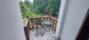 a balcony with a table and chairs on a porch at Phangan Paragon Resort & Spa by Pure Lifestyle in Haad Chao Phao