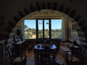a living room with a table and a large window at Relax house in Kanakis