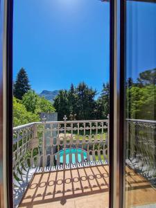 a view from a glass door of a balcony with a pool at Villa Sarchi in Grantola