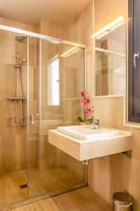 a bathroom with a sink and a glass shower at La Casa De Almocita in Dúrcal