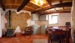 a kitchen with a table and a stove at Agriturismo Fienile del Canalone in Santa Fiora