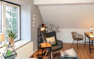 a living room with a chair and a window at Awesome Apartment In Bernburg With Wifi in Bernburg +10 photos