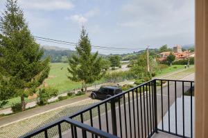 a balcony with a truck parked on a street at Posada Naturae in Cabárceno +39 photos