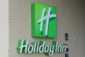 a sign on a wall with a holiday inn sign on it at Holiday Inn The Hague - Voorburg, an IHG Hotel in Voorburg