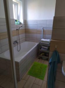 a bathroom with a bath tub and a sink at Apartmán Olomouc Nemilany in Olomouc