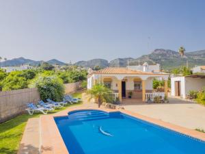a villa with a swimming pool and a house at Cubo's Finca el Cortijito de Herrera in Alhaurín el Grande