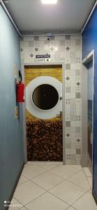 a door in a room with a wall with a window at SAXÔNiA HOTEL in Balneário Camboriú