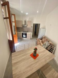 a living room with a table and a couch at Appartamento Orchidea in Parghelia