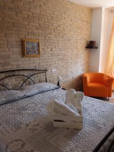 a bedroom with a bed with a stuffed animal on it at Primae Noctis Rooms in Roccascalegna