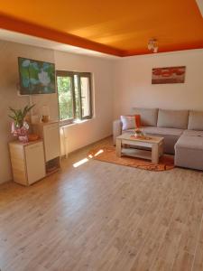 a living room with a couch and a table at Vila Bella Mia in Timotijevići