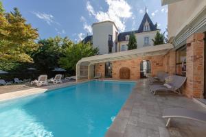 a swimming pool in the backyard of a house at Clos La Boëtie & Spa in Sarlat-la-Canéda
