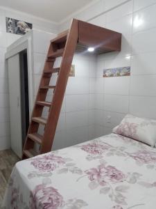 a bedroom with a bunk bed and a ladder at Trip Adventure Poa in Porto Alegre