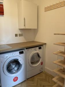 a laundry room with a washing machine and a counter at Galwad y Mor - Balcony, Sea View, Short walk to beach & several eateries in Haverfordwest