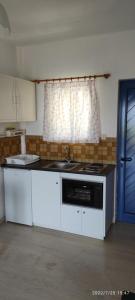 a kitchen with a sink and a stove top oven at Helen's appartments in Galaxidhion