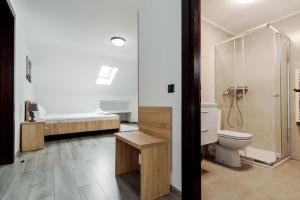 a bathroom with a toilet and a sink and a tub at Agropensiunea Andrei & Ianis in Dăeşti
