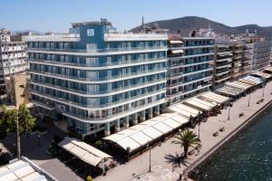a large blue building next to the water at Paliria Hotel in Chalkida
