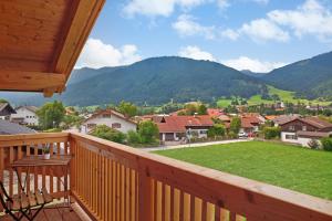 a balcony with a view of a town and mountains at Alpenloft Meditz in Unterammergau